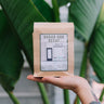 Alana's Coffee Roasters' Sugar H2O Decaf coffee bag. The label shows a drawing of Alana's in West Hollywood on a pale purple backdrop.