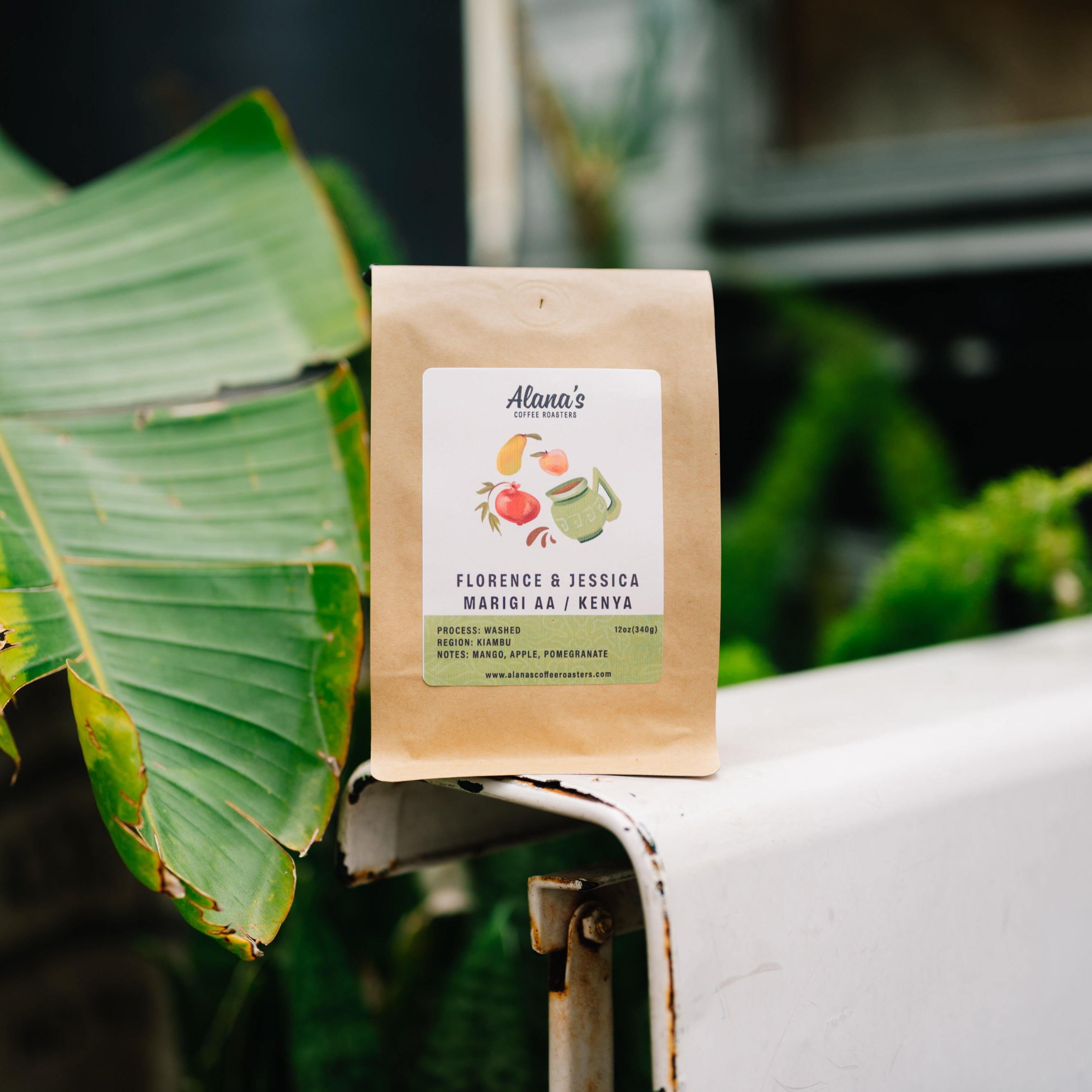 Brown kraft coffee bag with Alana's Coffee Roasters label and tropical fruit illustration for Florence & Jessica Marigi AA Kenya 12oz