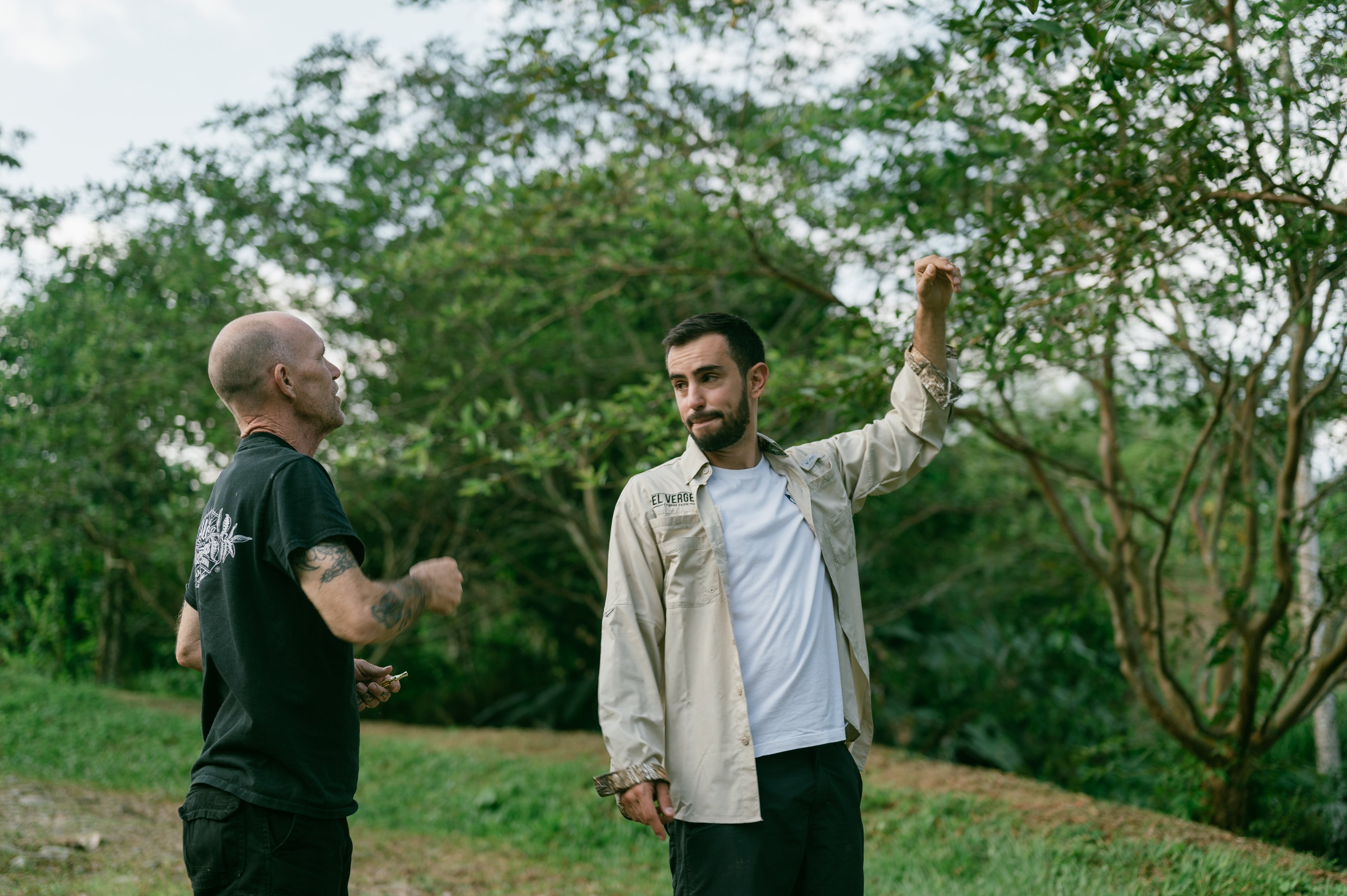 Two men discuss the coffee plants in Colombia.